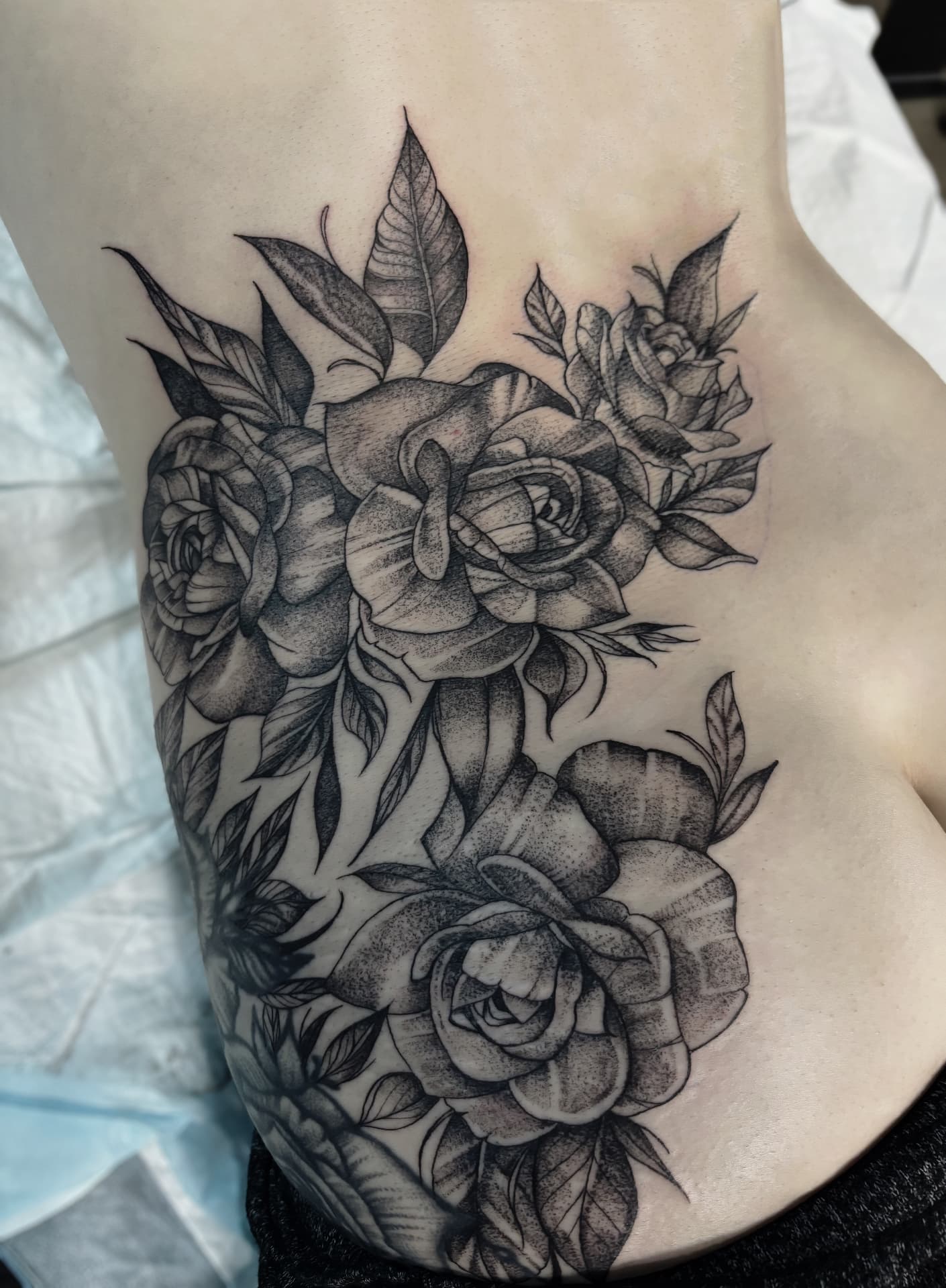 Dotwork roses and foliage rib piece in black and grey
