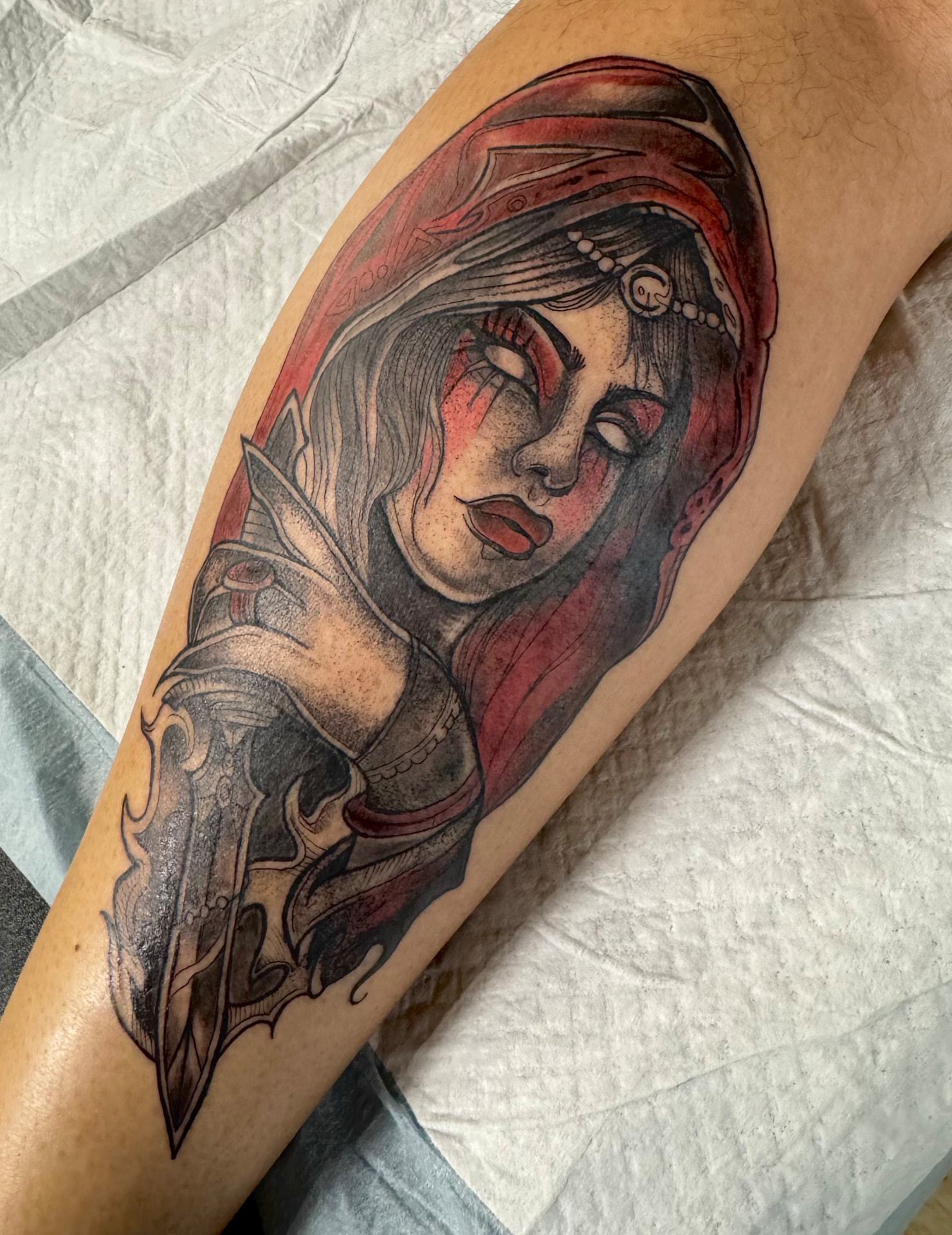 Veiled woman in a red hood with an ornate dagger, black and grey with red wash