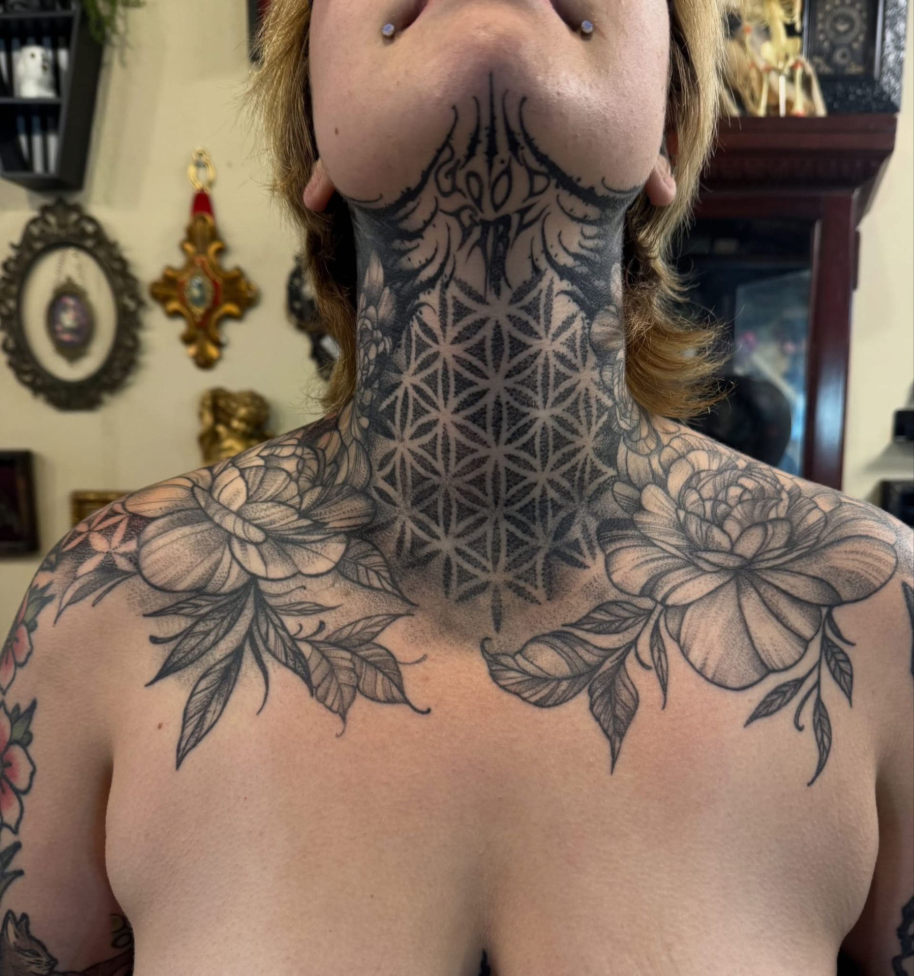 Flower of life throat mandala with dotwork peonies across the chest
