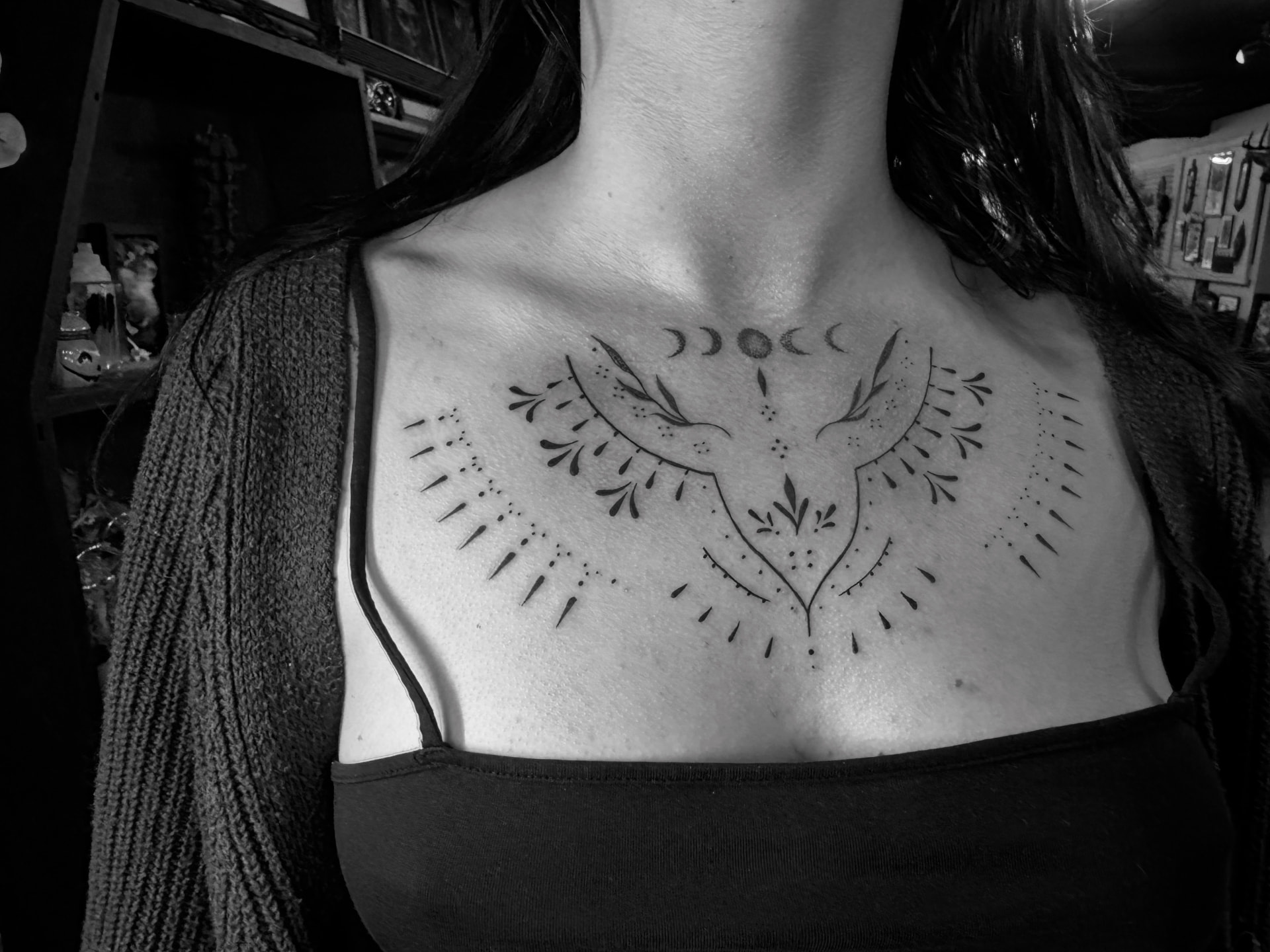 Fine line ornamental chest piece with moon phases and botanical filigree